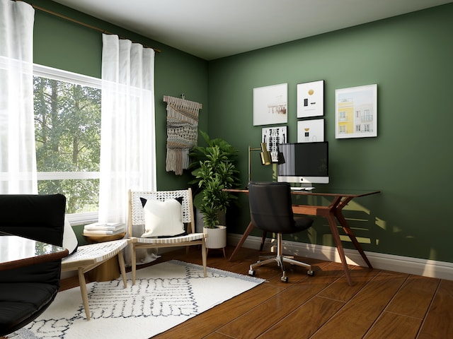 Home office setup with a green-walled interior