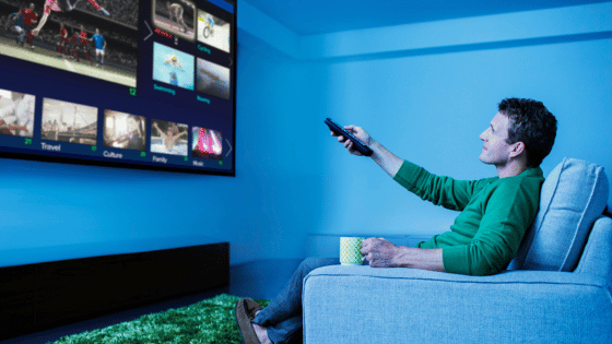 Man watching IPTV in living room.